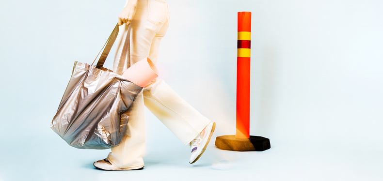 A woman and a traffic pole